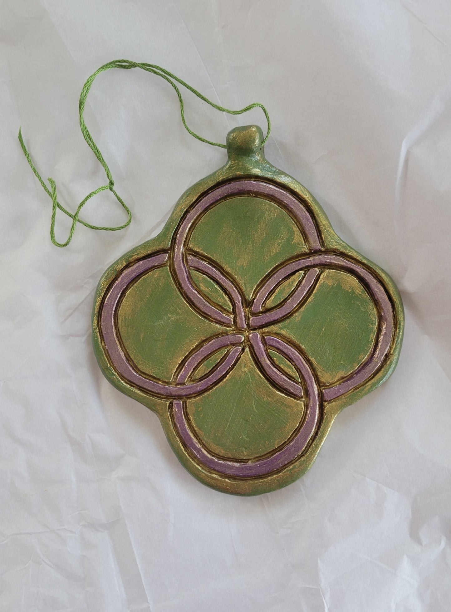 Handmade green hanging ornament with four intertwining metallic purple circles and gold highlights. Beautiful Christmas decoration. Handmade out of clay. Gifts for history lovers.