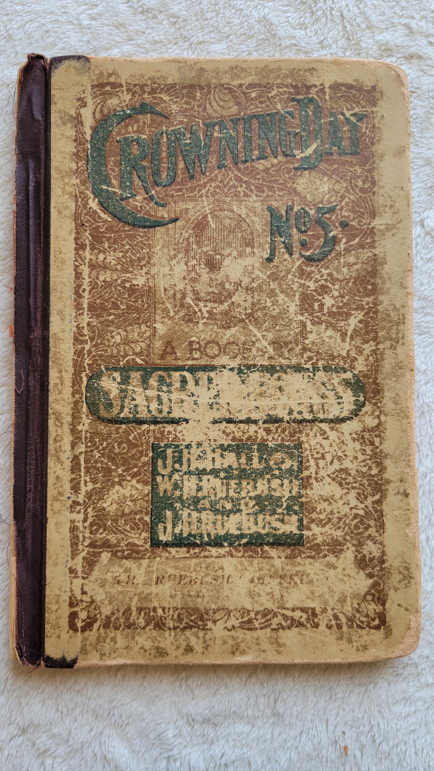 Antique book Crowning Day No. 5 is a Christian hymn book, copyrighted in 1902 by J. H. Hall, W. H. Ruebush, and J. H. Ruebush and published by the Ruebush-Kieffer Company, Dayton, Virginia. View of front cover.