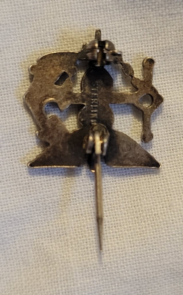 A sterling silver U.S. Public Health Service Commissioned Corps insignia button. Back view.