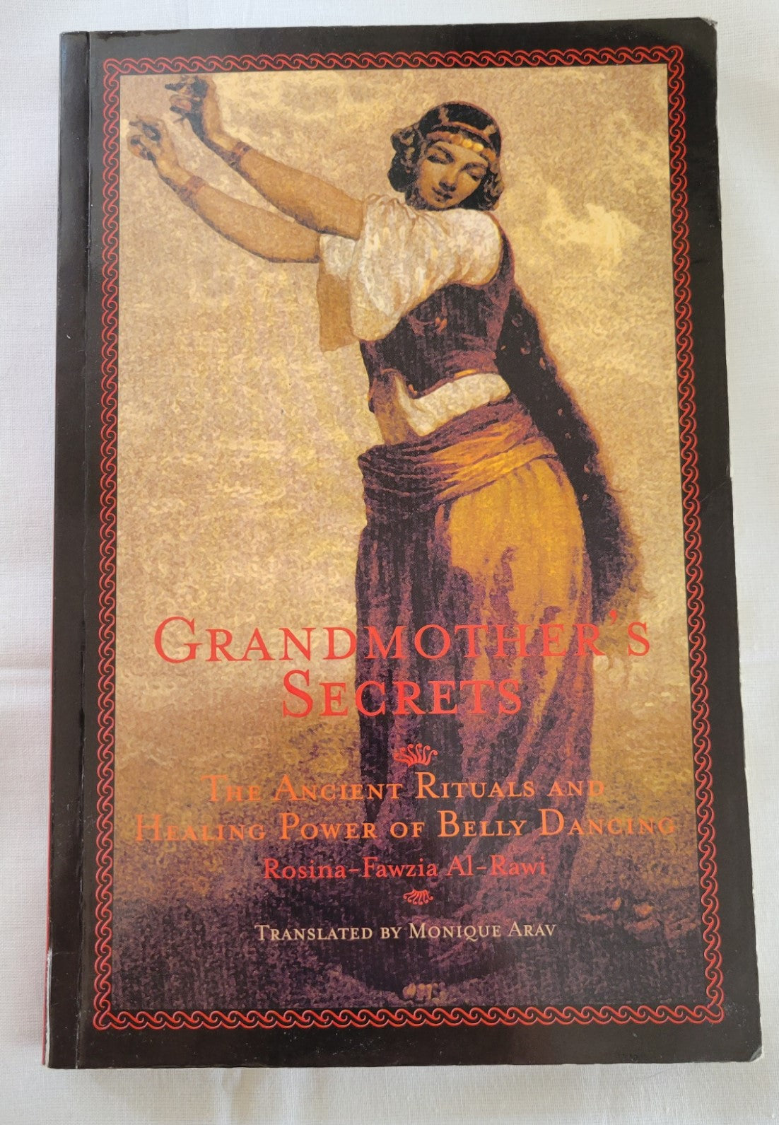 Used book for sale “Grandmother's Secrets: The Ancient Rituals and Healing Power of Belly Dancing” written by Rosina-Fawzia Al-Rawi, translated by Monique Arav.  View of front cover.