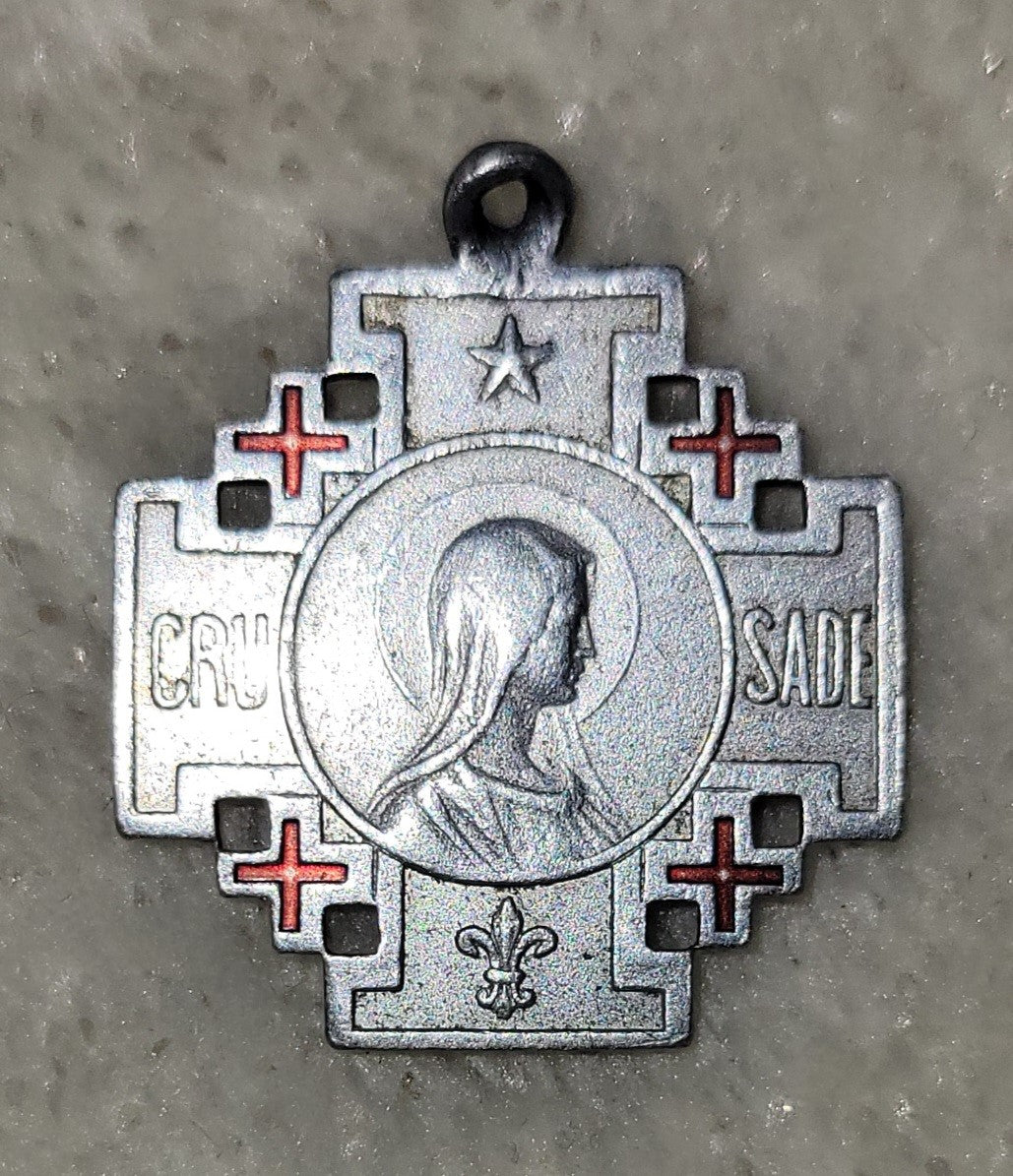 Jerusalem Cross of the Crusades pendent - a large cross surrounded by four smaller Greek crosses.  On one side of this pendent is and image of Jesus with the Chi Rho symbol (the P over the X) at the bottom.  The Greek letters to the side of the image of Jesus are alpha and omega, symbolizing the beginning and the end. On the other side is an image of Mary, the word "Crusade", the fleur de lis, and a star. View of front.