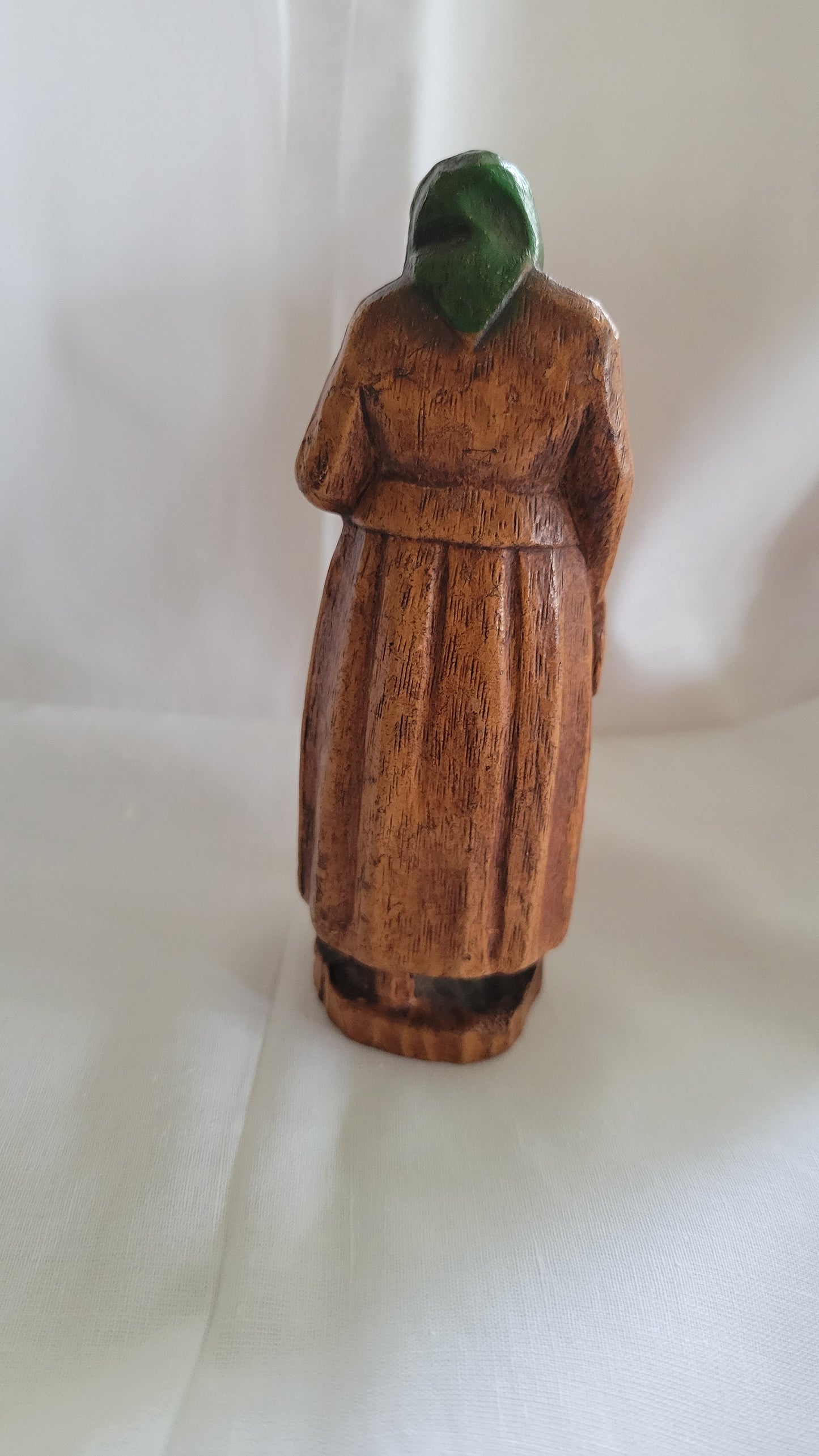 Small Jewish, Yiddish grandmother or Bubbe figure, antique, holding Jewish Bible, possibly SyrocoWood. Back view.