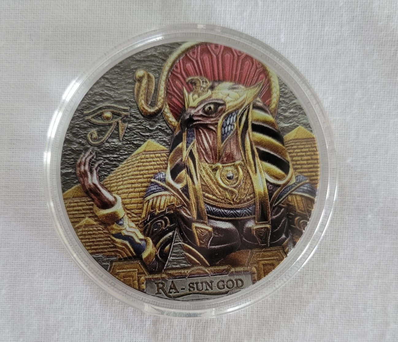 Collectible coin, 2019 one dollar, Cook Island coin with the Egyptian sun god Ra on one side and Queen Elizabeth II on the other. Front view.