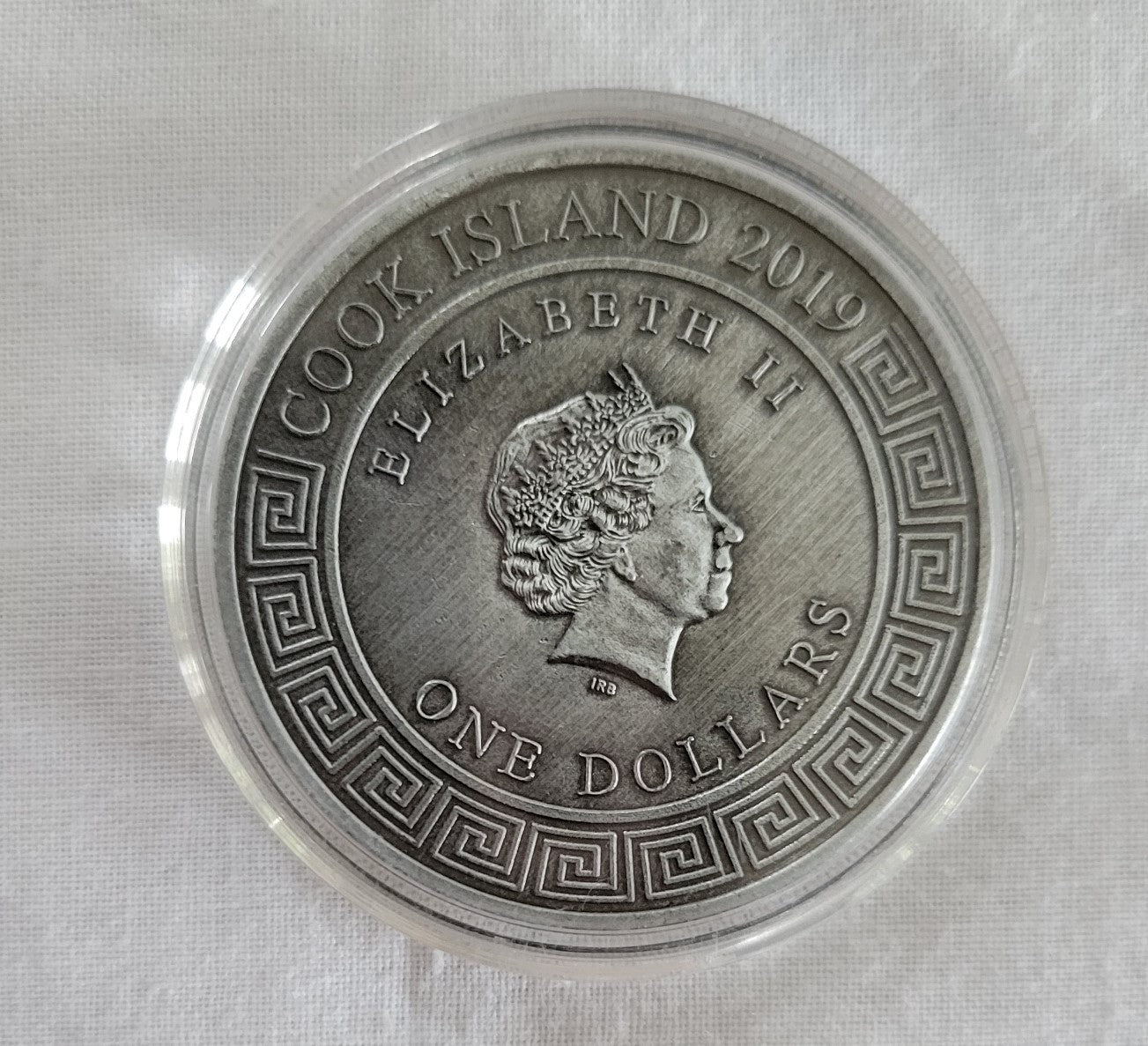 Collectible coin, 2019 one dollar, Cook Island coin with the Egyptian sun god Ra on one side and Queen Elizabeth II on the other. Back view.