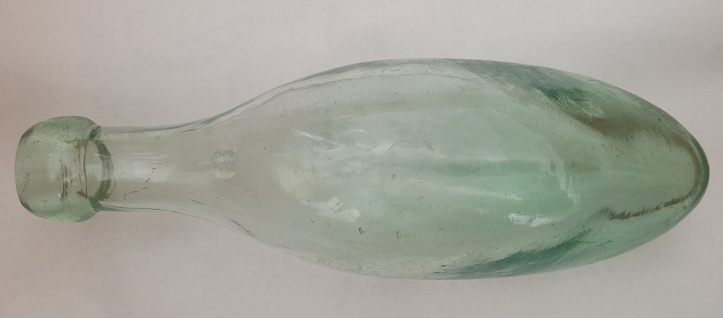 Antique torpedo bottle made with clear green glass.