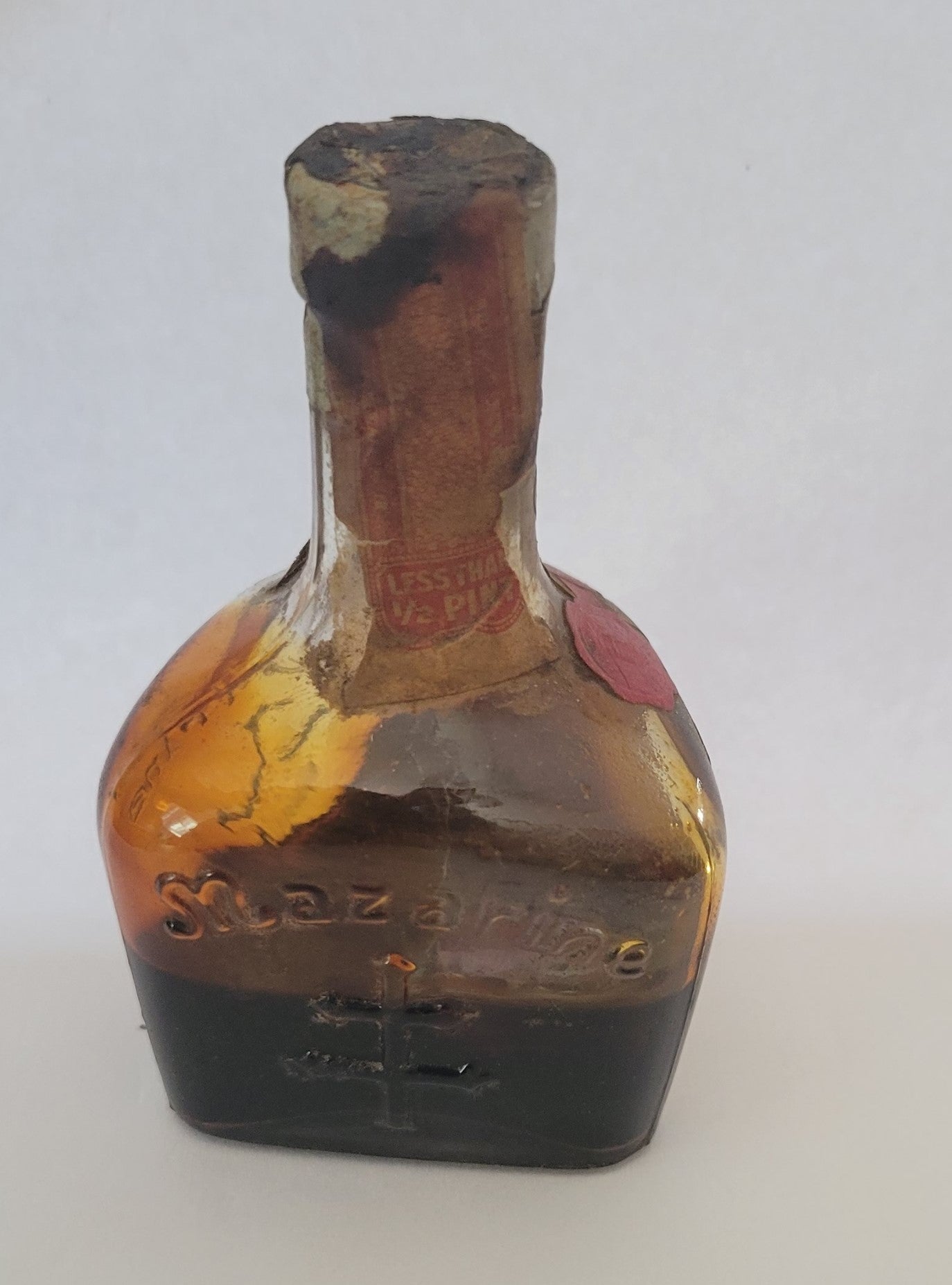 Vintage liquor bottle, little Mazarine liquor bottle from Argentina with State of Maryland Liquor Excise Tax sticker on the front. Back view.