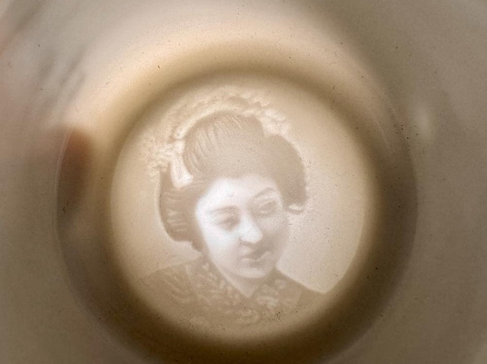 Vintage Japanese lithophane teacup and saucer with image of woman on bottom of cup, image view