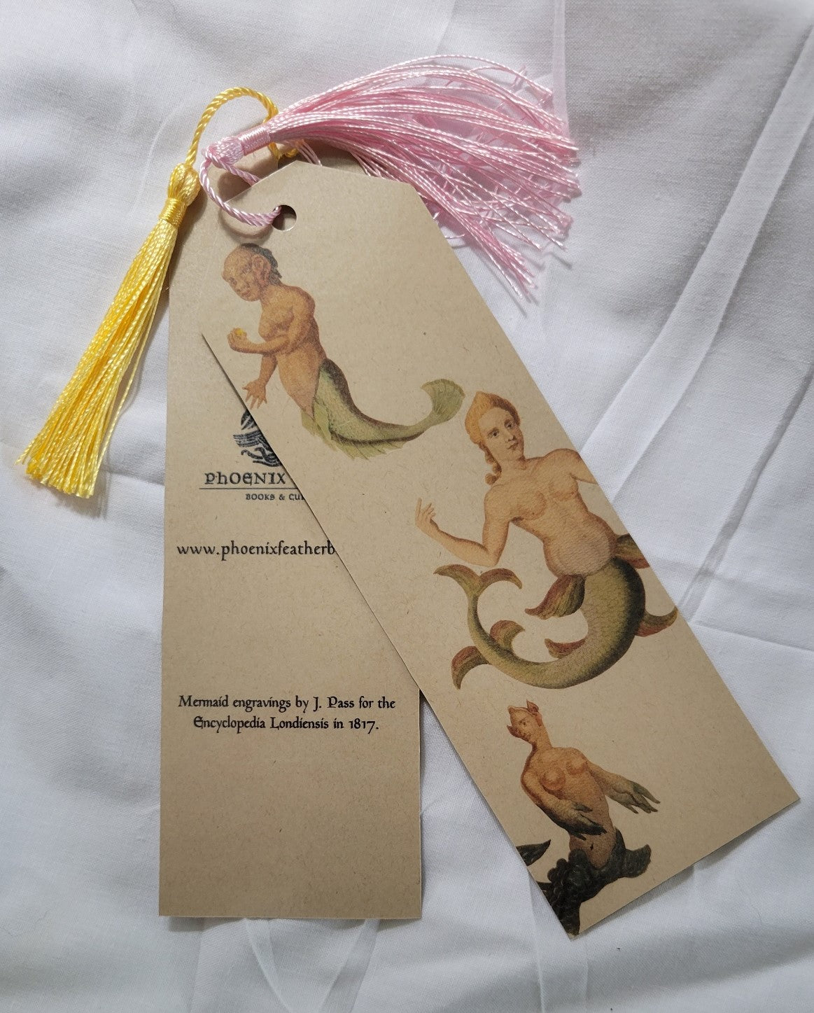 Handmade bookmark by Phoenix Feather Books & Curios, laminated bookmark, decorated with mermaid engravings from the Encyclopedia Londiensis, 1817.  Size: 2.25" x 7"
