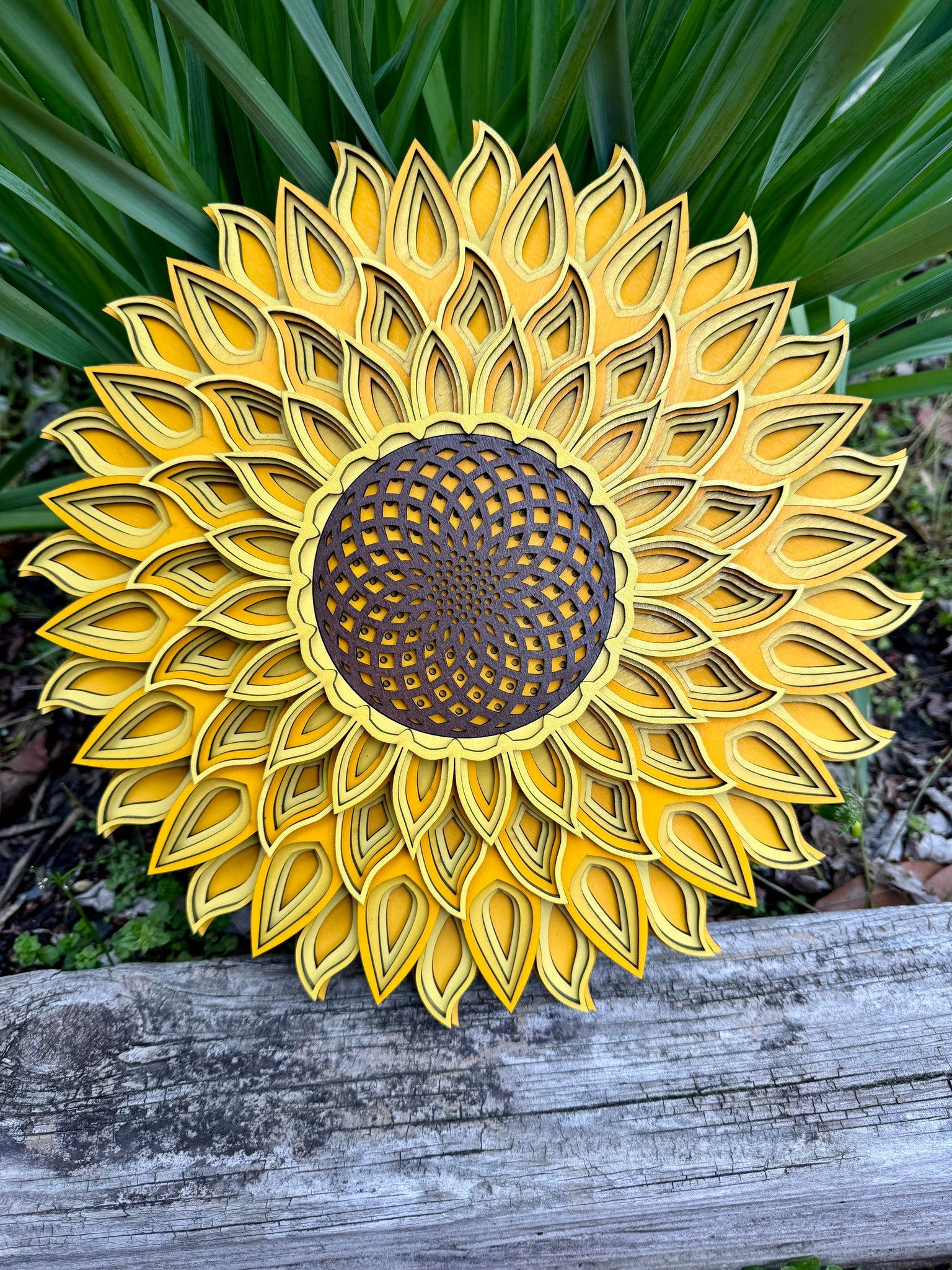 A beautiful sunflower mandala, painted with bright shades of yellow, a favorite flower among gardeners and artists alike.
