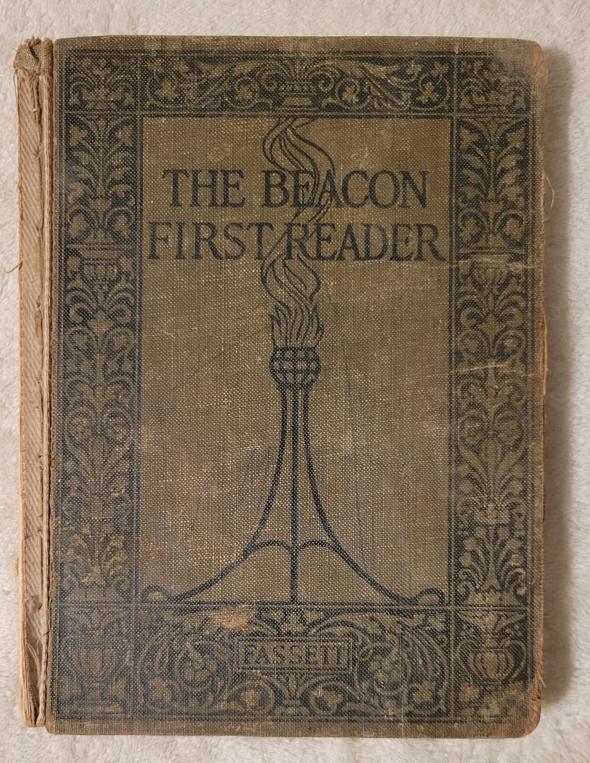 Antique book for sale "The Beacon First Reader" by James H. Fassett, Ginn and Company, 1913.  A child's schoolbook. Front cover.