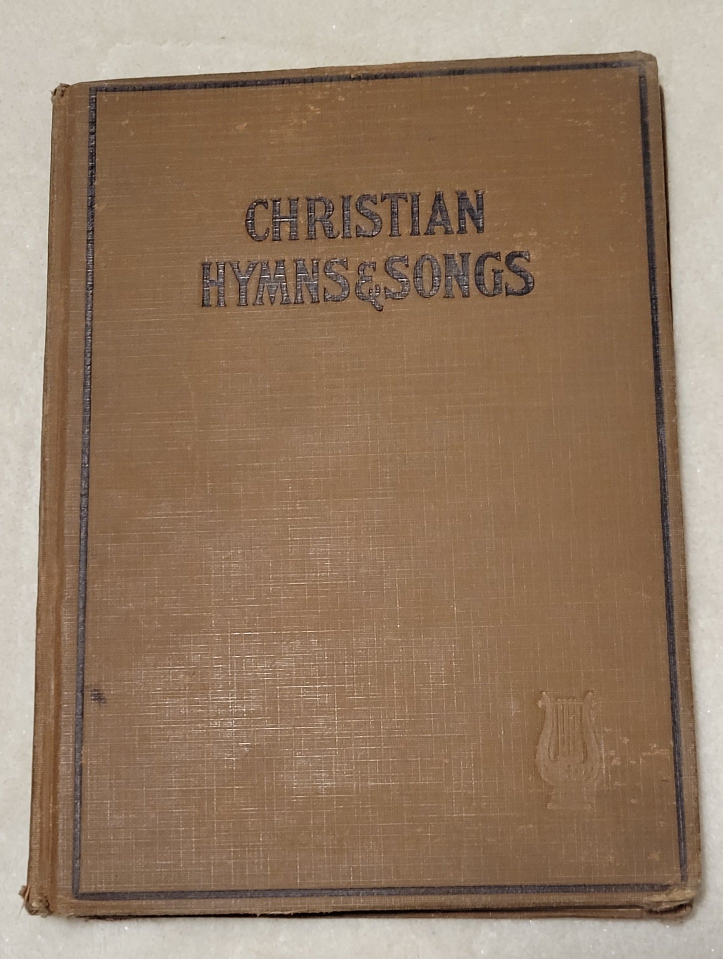 An antique book of Christian hymns and songs, published by Hall-Mack Co in Philadelphia in 1931. Front view.