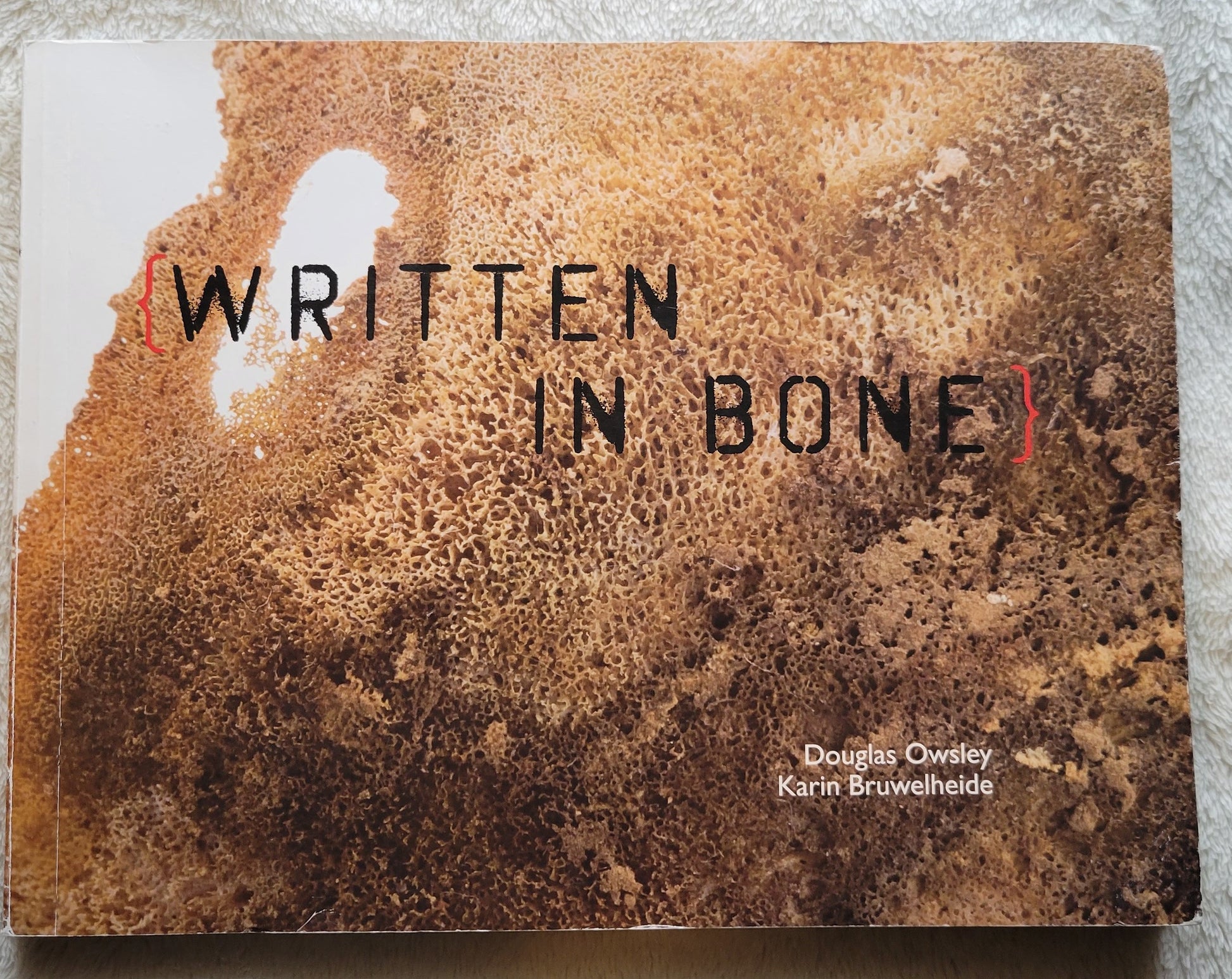 Used book for sale "Written in Bone" by Douglas Owsley and Karin Bruwelheide, published by LeanTo Press, 2009. Front cover.