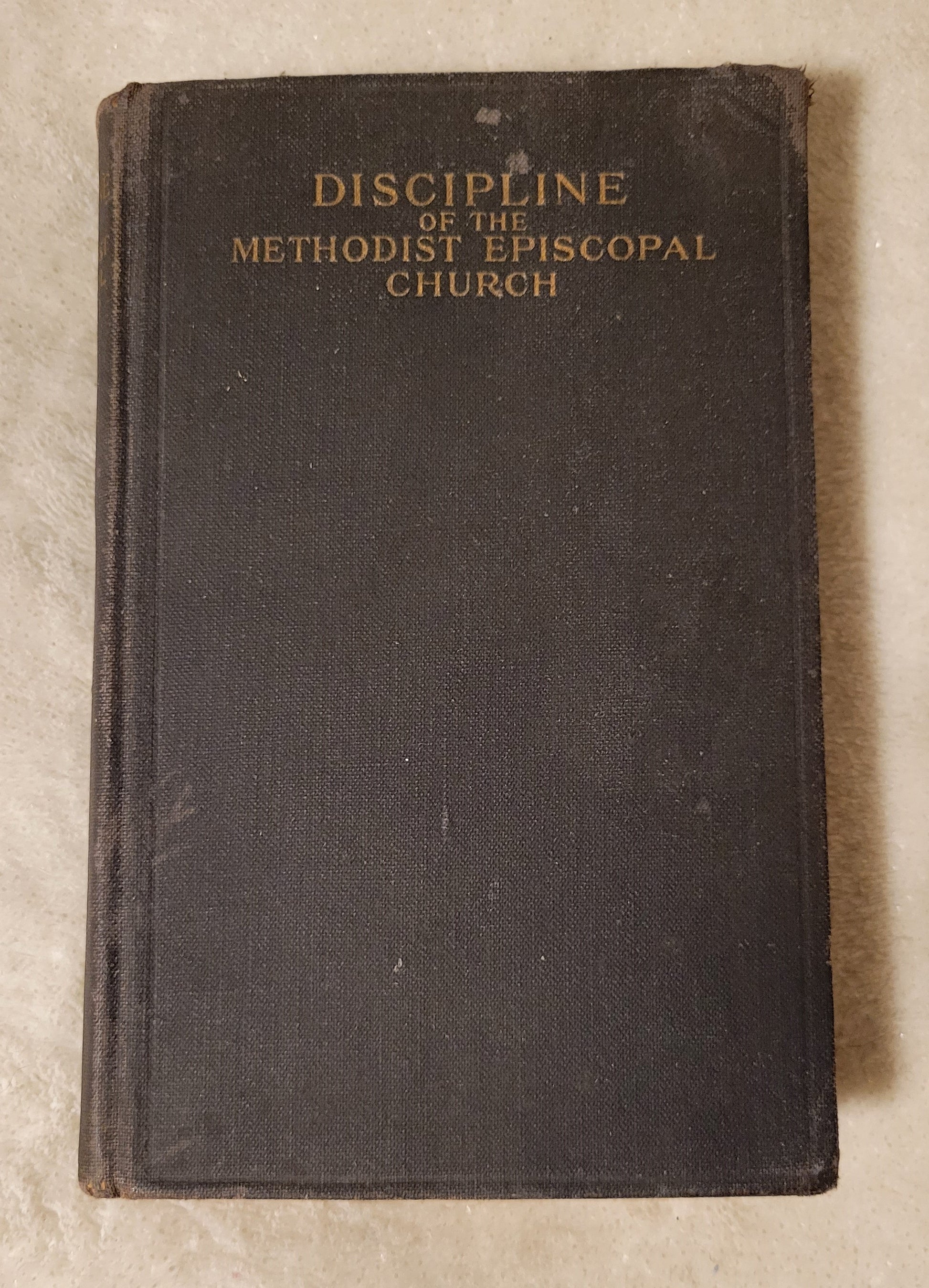 Antique book "Doctrines and Discipline of the Methodist Episcopal Church" published by the Methodist Book Concern, 1912. View of front cover.