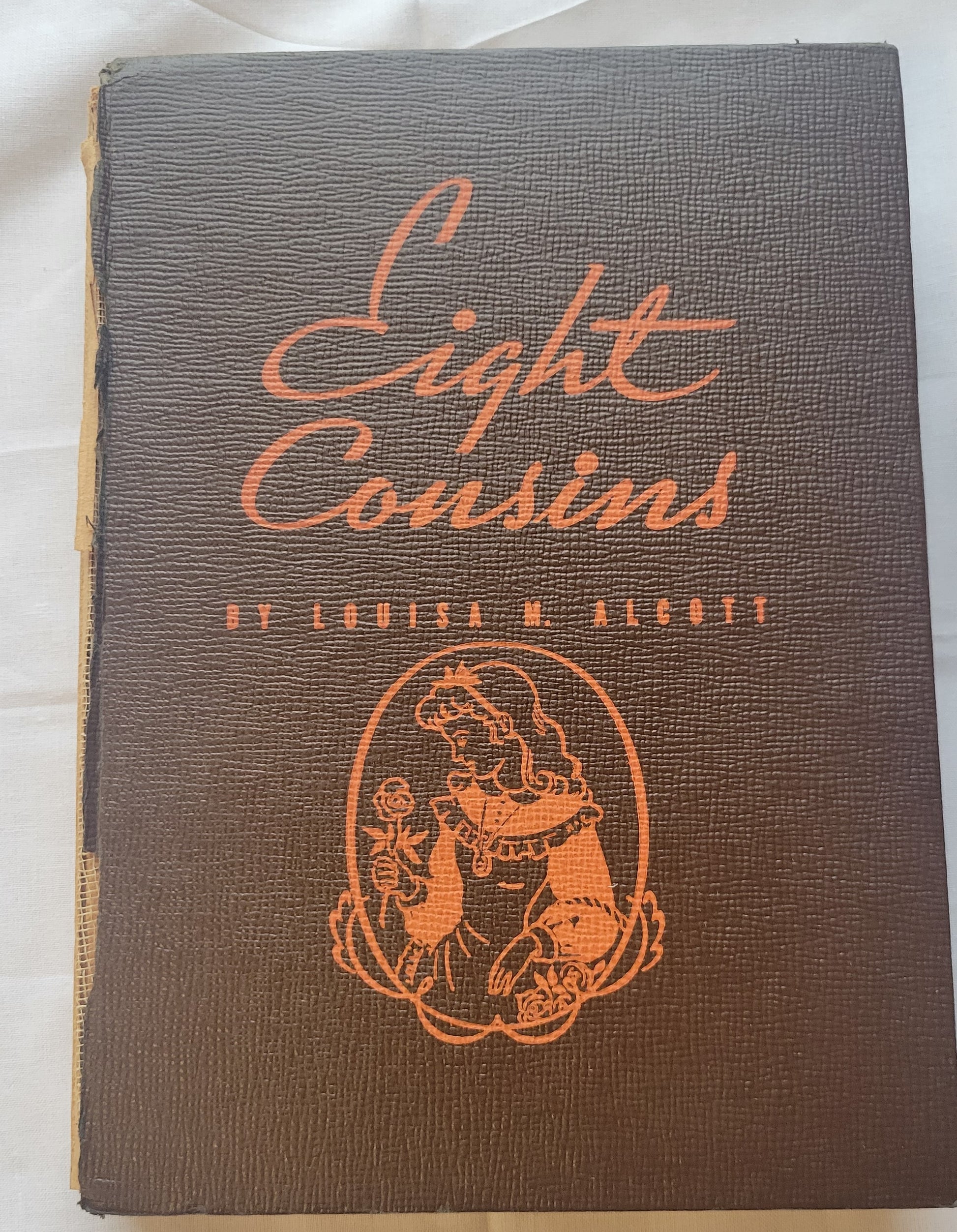Vintage book "Eight Cousins" by Louisa May Alcott (author of Little Women), illustrated by Erwin L. Hess, and published by Whitman Publishing Company in 1940. View of front cover.