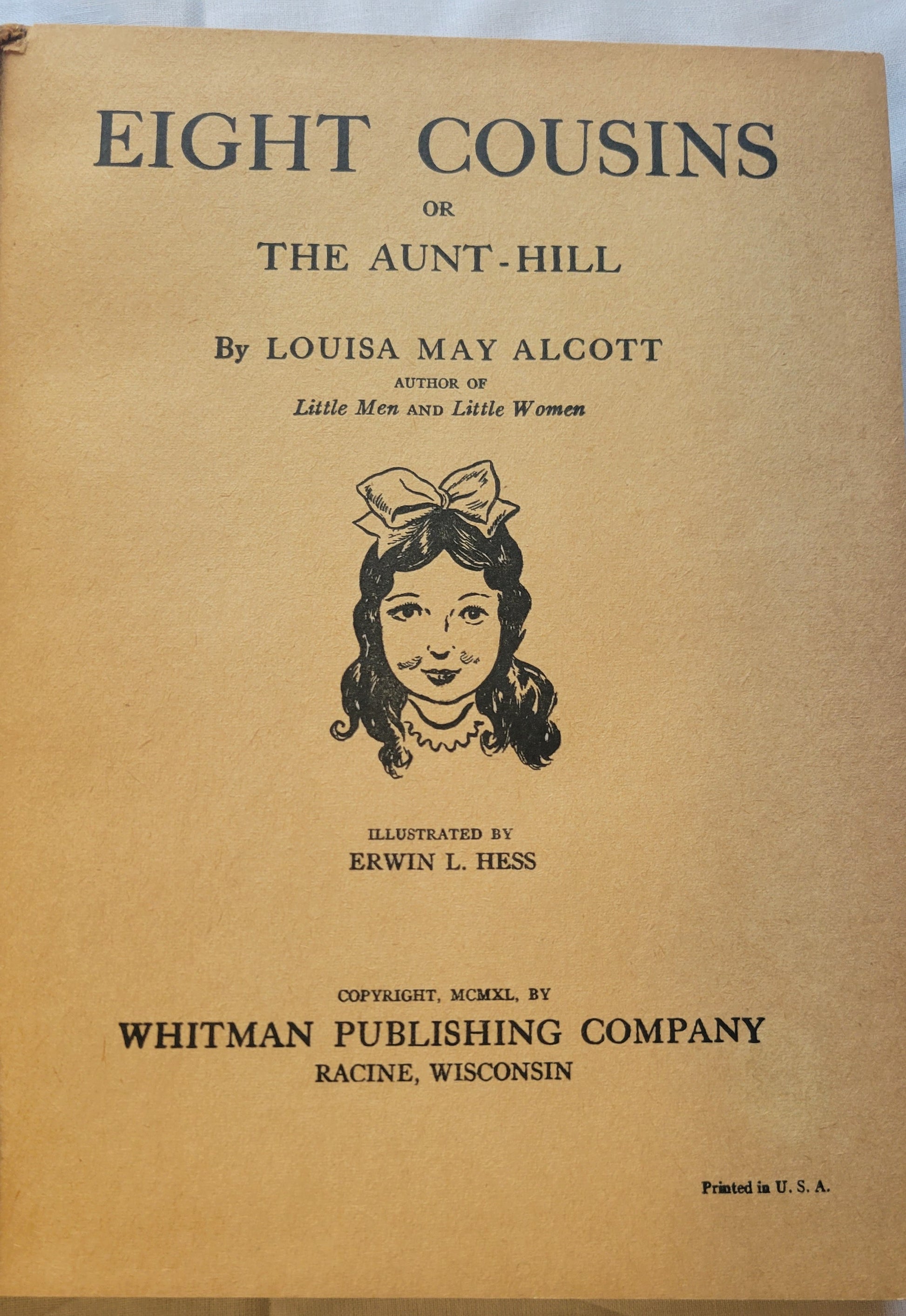 Vintage book "Eight Cousins" by Louisa May Alcott (author of Little Women), illustrated by Erwin L. Hess, and published by Whitman Publishing Company in 1940. View of inside title page.