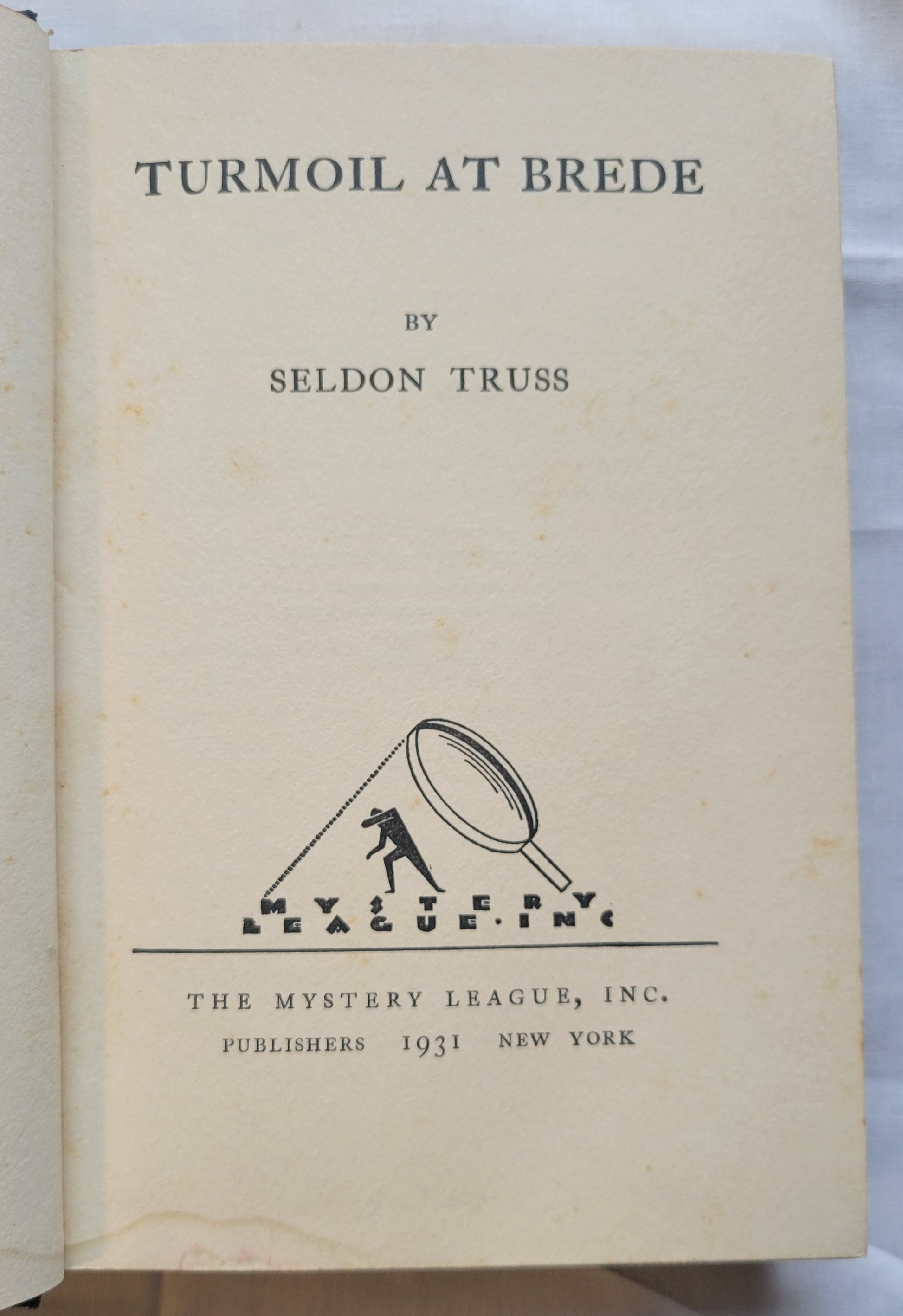 Antique book for sale “Turmoil at Brede, First Edition” by Seldon Truss, published by The Mystery League in 1931. Title page.