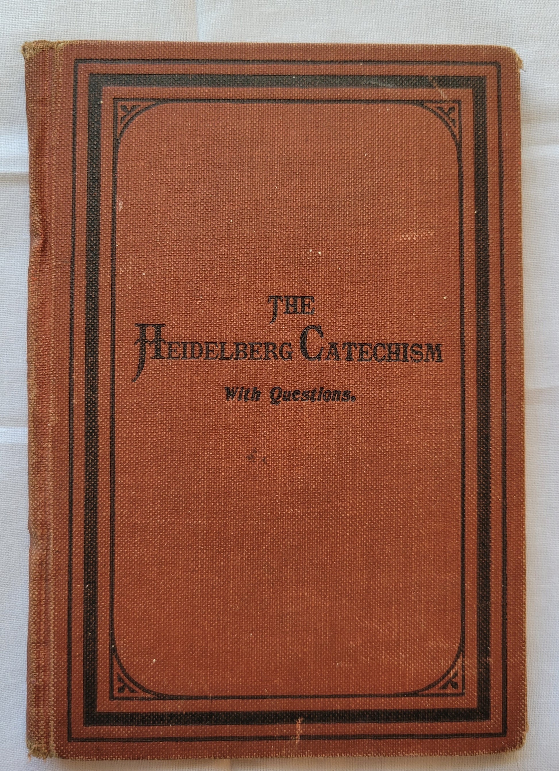 Antique book for sale "The Heidelberg Catechism: With Questions for the Catechetical Class and the Sunday-School by Rec. Aaron Spangler, A.M.", published in 1899 by the Central Publishing House. Front cover.