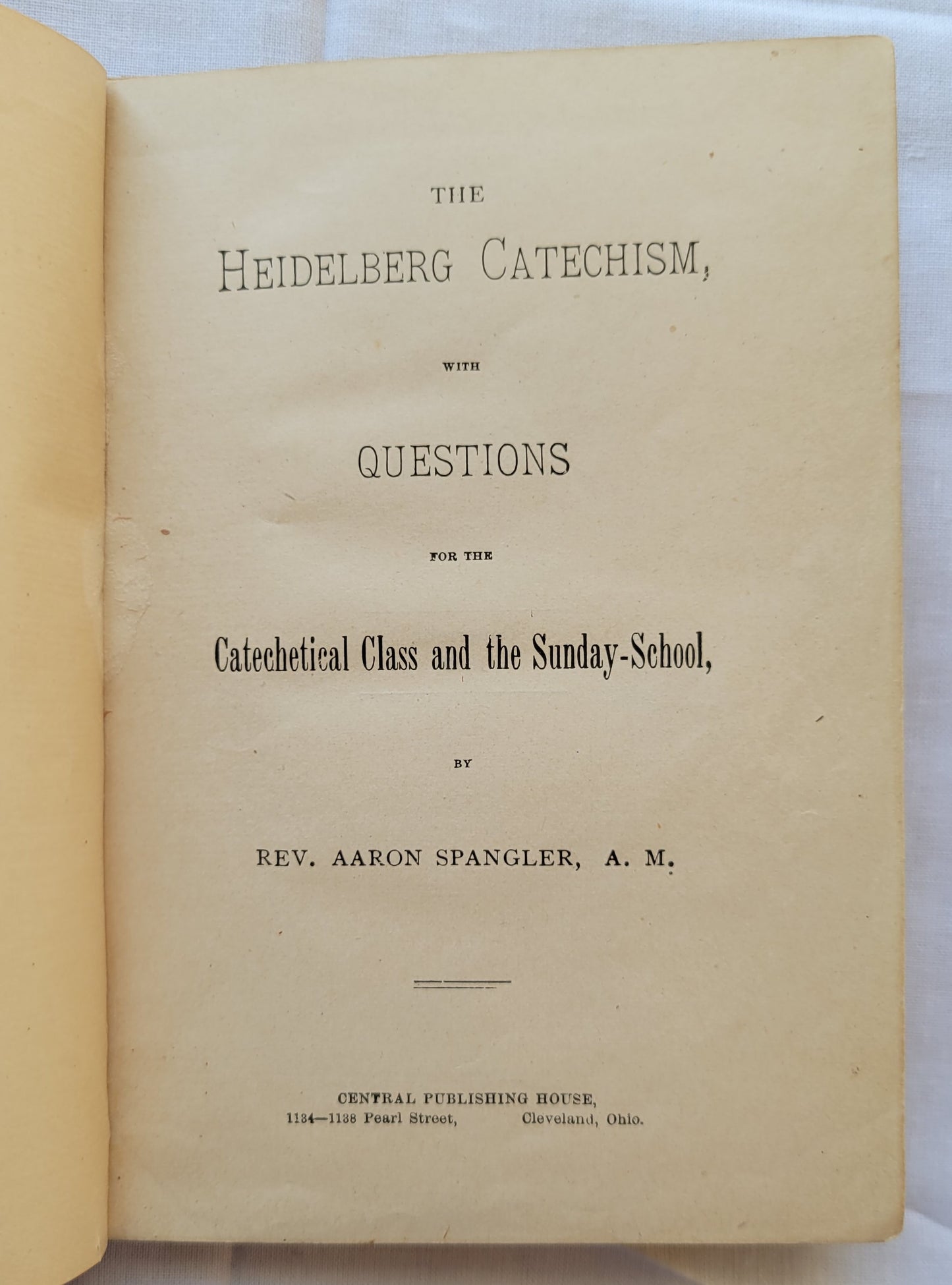 Antique book for sale "The Heidelberg Catechism: With Questions for the Catechetical Class and the Sunday-School by Rec. Aaron Spangler, A.M.", published in 1899 by the Central Publishing House. Title page.