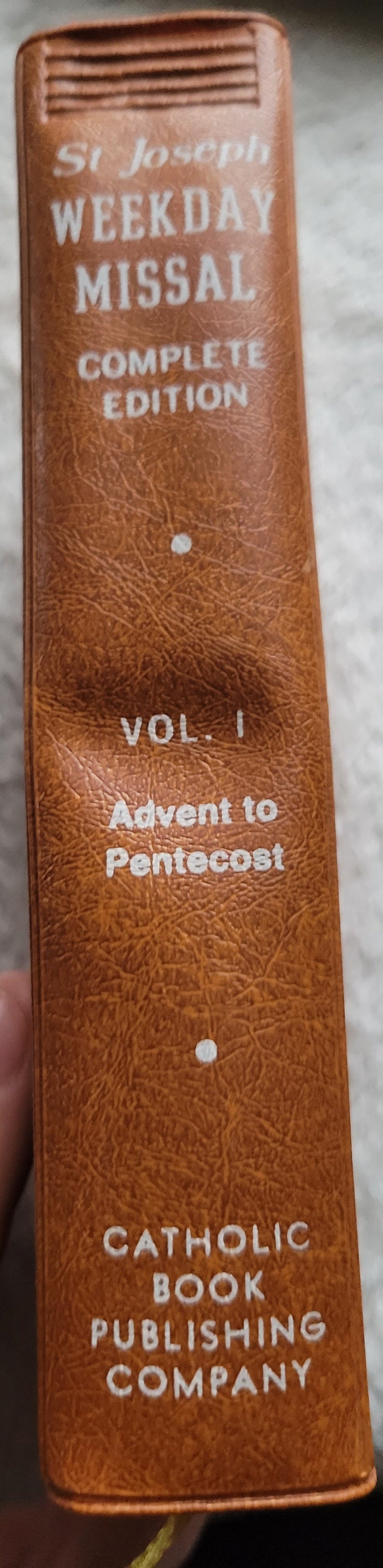 Vintage book for sale, "New....St. Joseph Weekday Missal Vol 1: Advent to Pentecost" Complete Edition, by the Catholic Book Publishing Company, "In accordance with Vatican II". View of spine