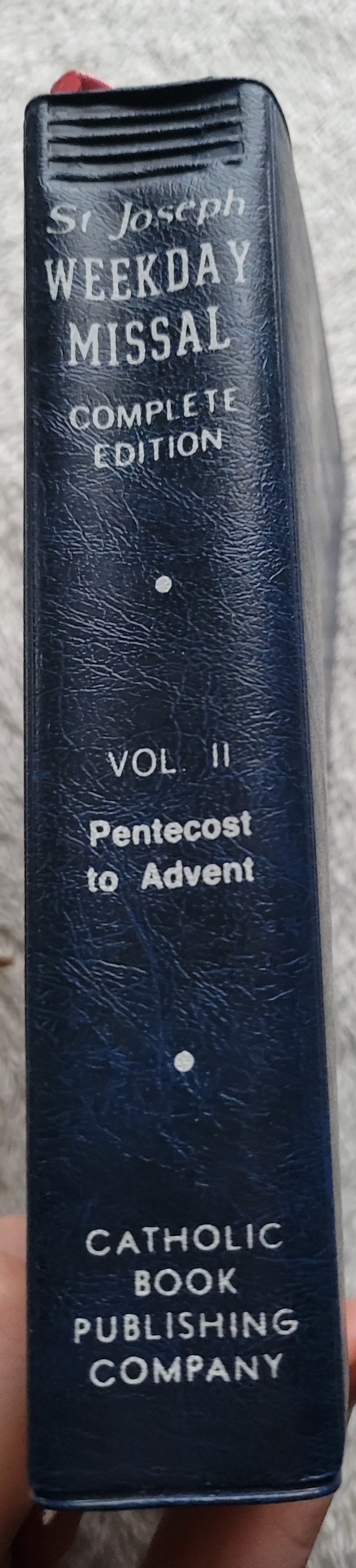 Vintage book for sale, "New....St. Joseph Weekday Missal Vol 2: Advent to Pentecost" Complete Edition, by the Catholic Book Publishing Company, "In accordance with Vatican II". View of spine.