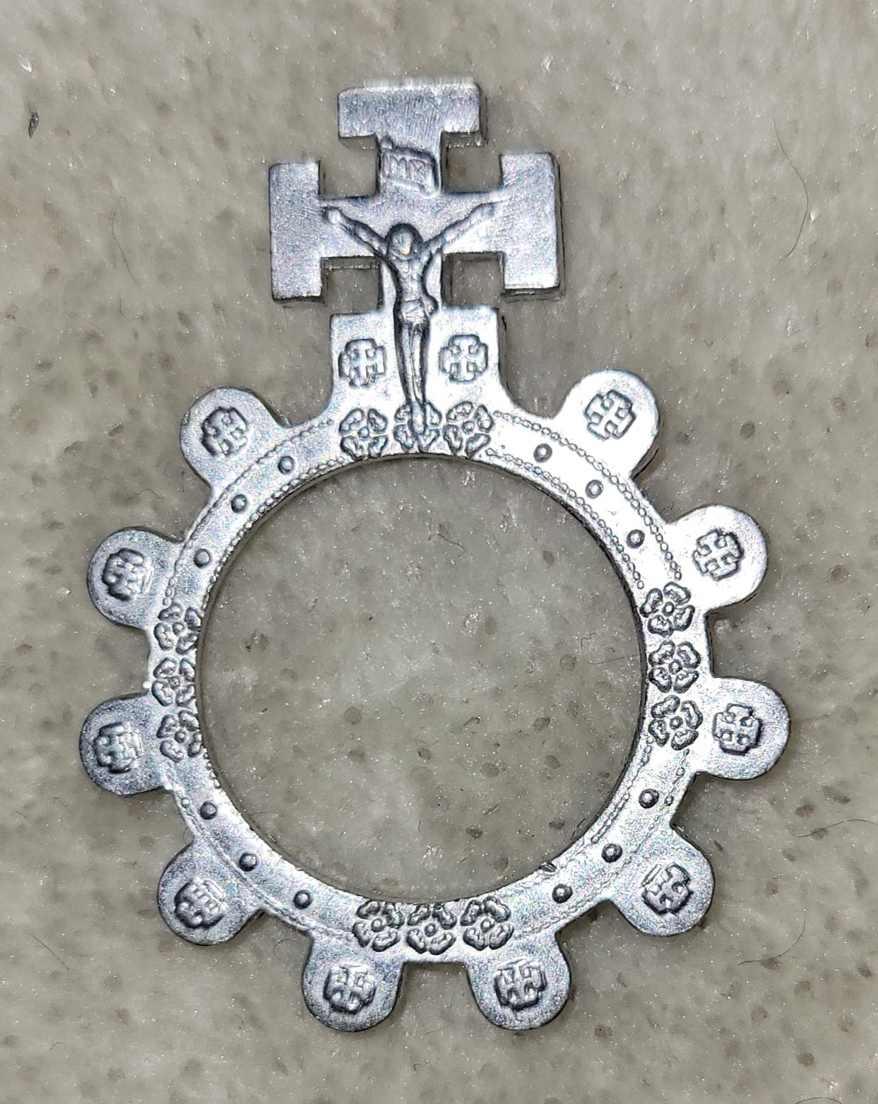Small metal religious, Christian rosary ring with crucifix.  Front view.