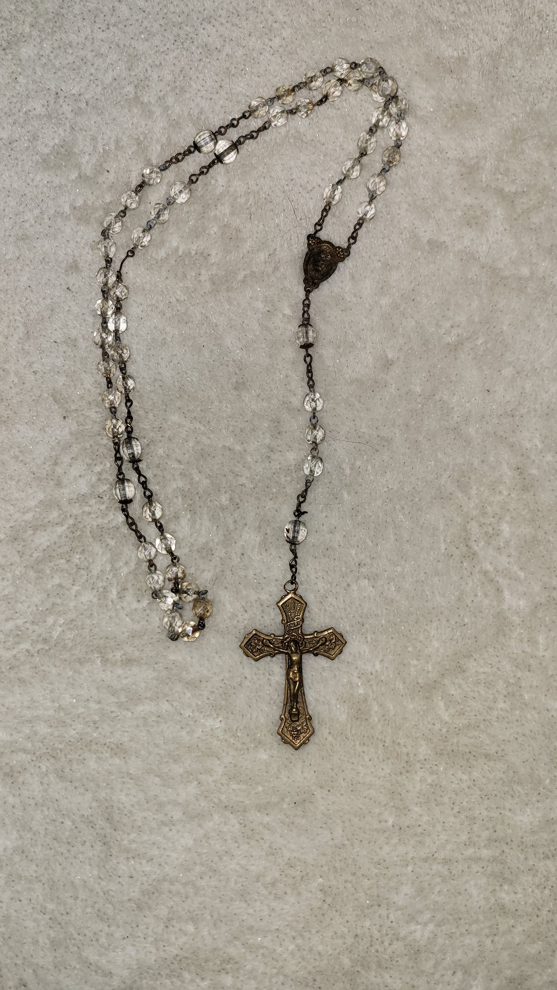 Christian Catholic rosary with crucifix and clear beads.  Overall view.