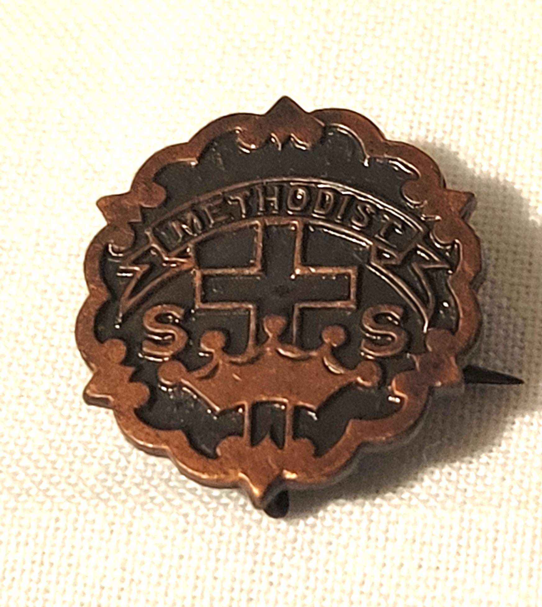 Vintage copper Methodist Sunday school pin. Front view.