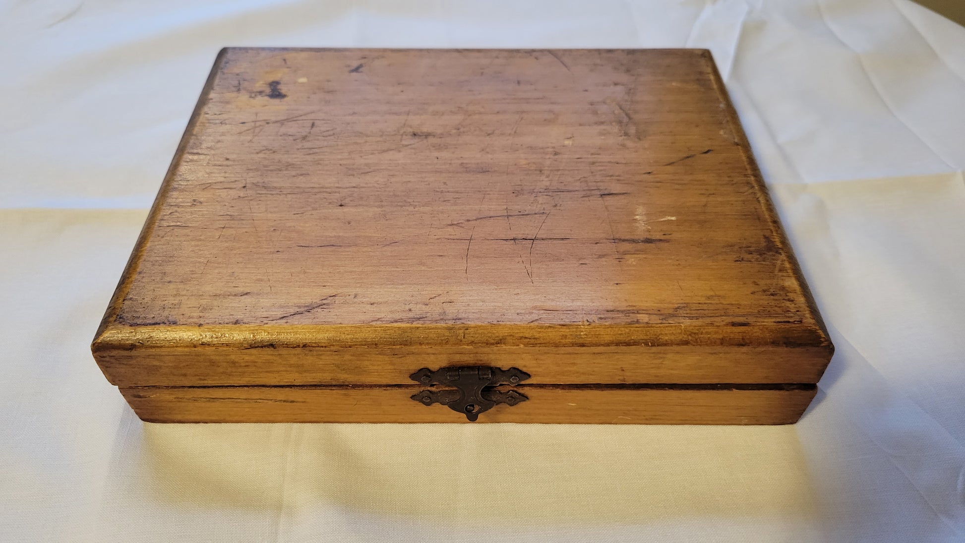 Antique wooden box that held the Fulton Office Printing Outfit custom rubber stamp kit.  View of closed front and top.