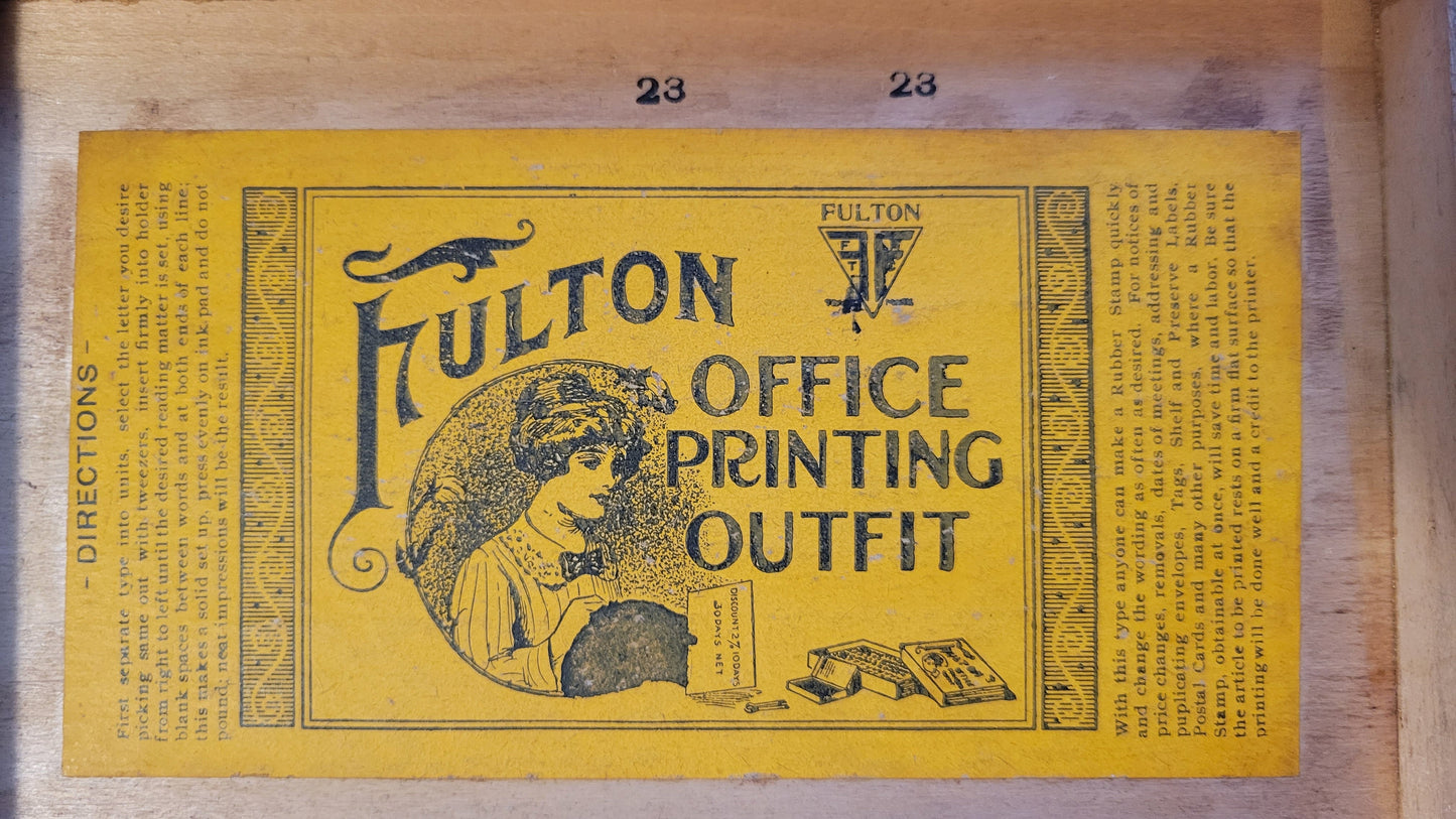 Antique wooden box that held the Fulton Office Printing Outfit custom rubber stamp kit.  Close-up view of inside sticker.