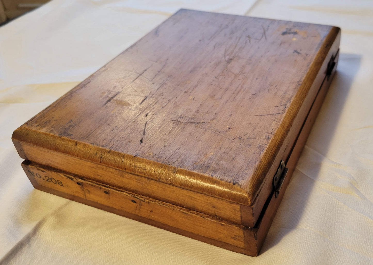 Antique wooden box that held the Fulton Office Printing Outfit custom rubber stamp kit.  View of back corner.