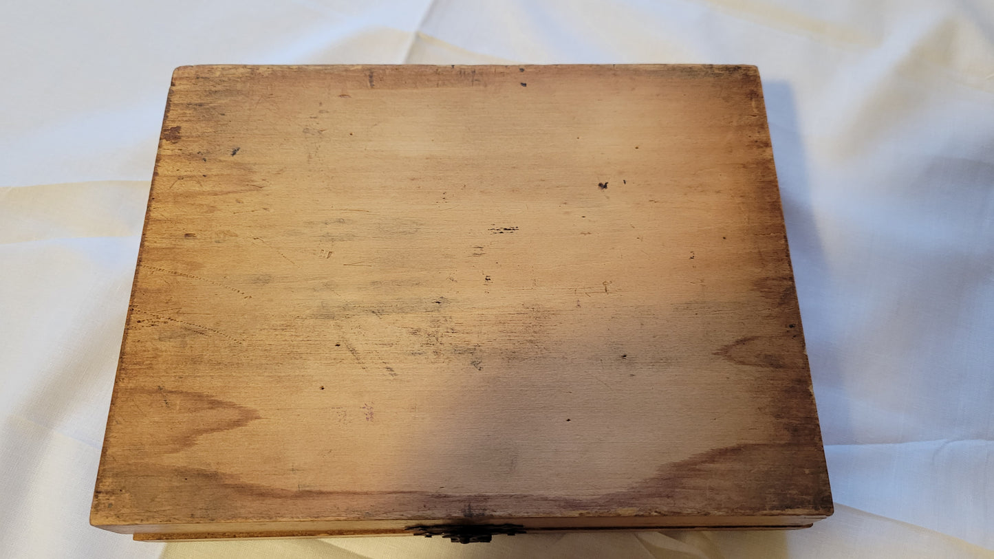 Antique wooden box that held the Fulton Office Printing Outfit custom rubber stamp kit.  View of bottom.
