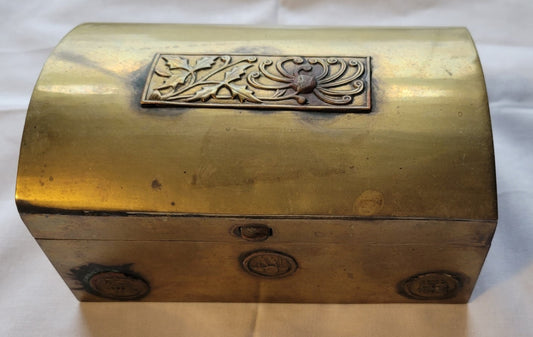 Antique brass box curio made in China, with a domed lid. The interior bottom has wood inserts on three side (one side is missing). The exterior has welded medallions with Chinese characters and designs. View of top and front.